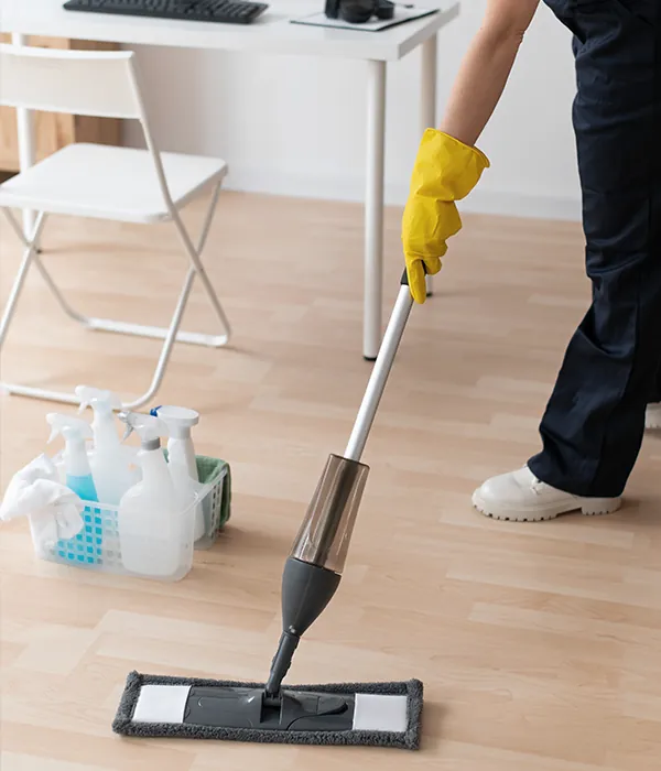 A cleaner mopping a floor.