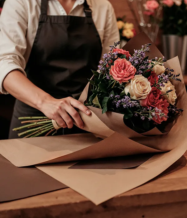 A florist wrapping a bouquet.
