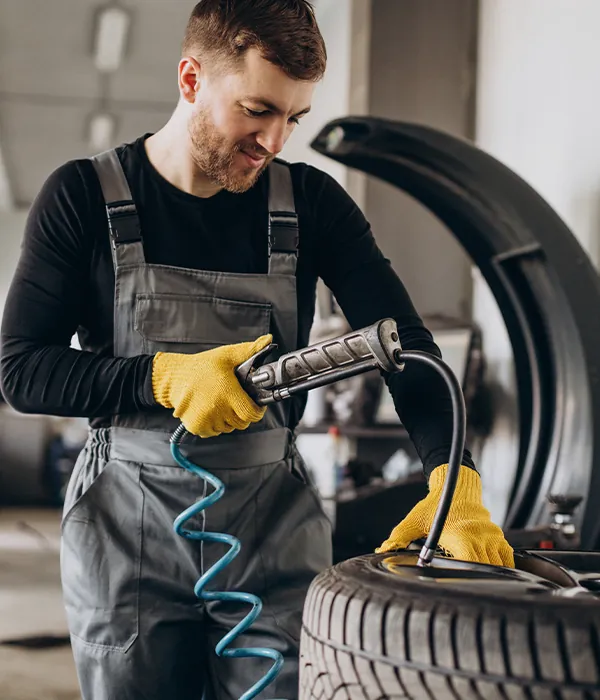 A mechanic inflating a tyre.